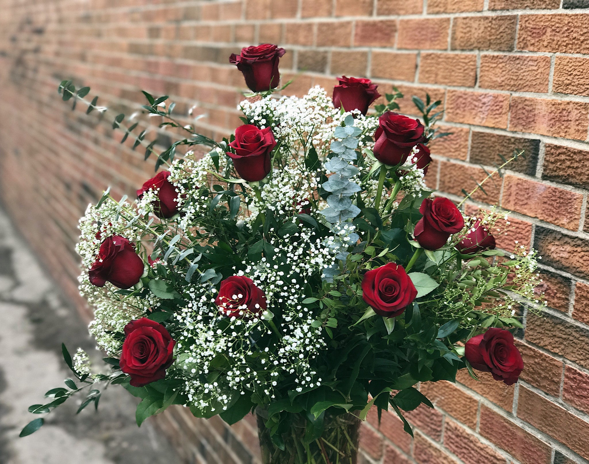 A Dozen Classic Roses Arranged in a Vase